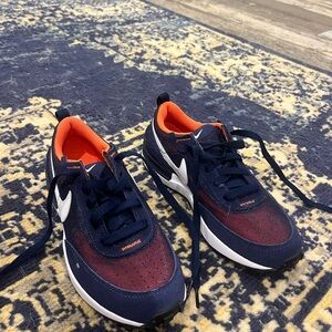 boys navy nikes with mesh and orange accent. never worn. size 3